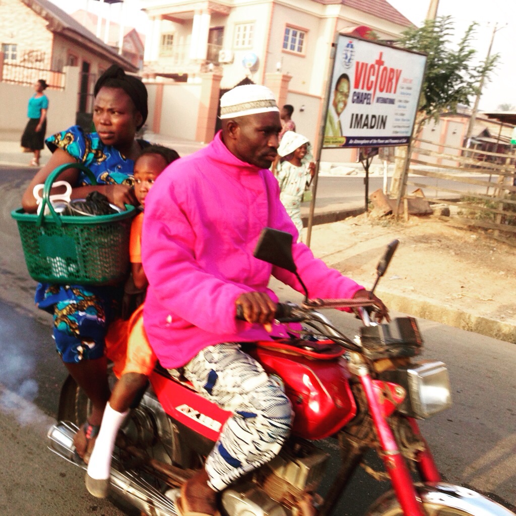 Motorcycling to School in Nigeria