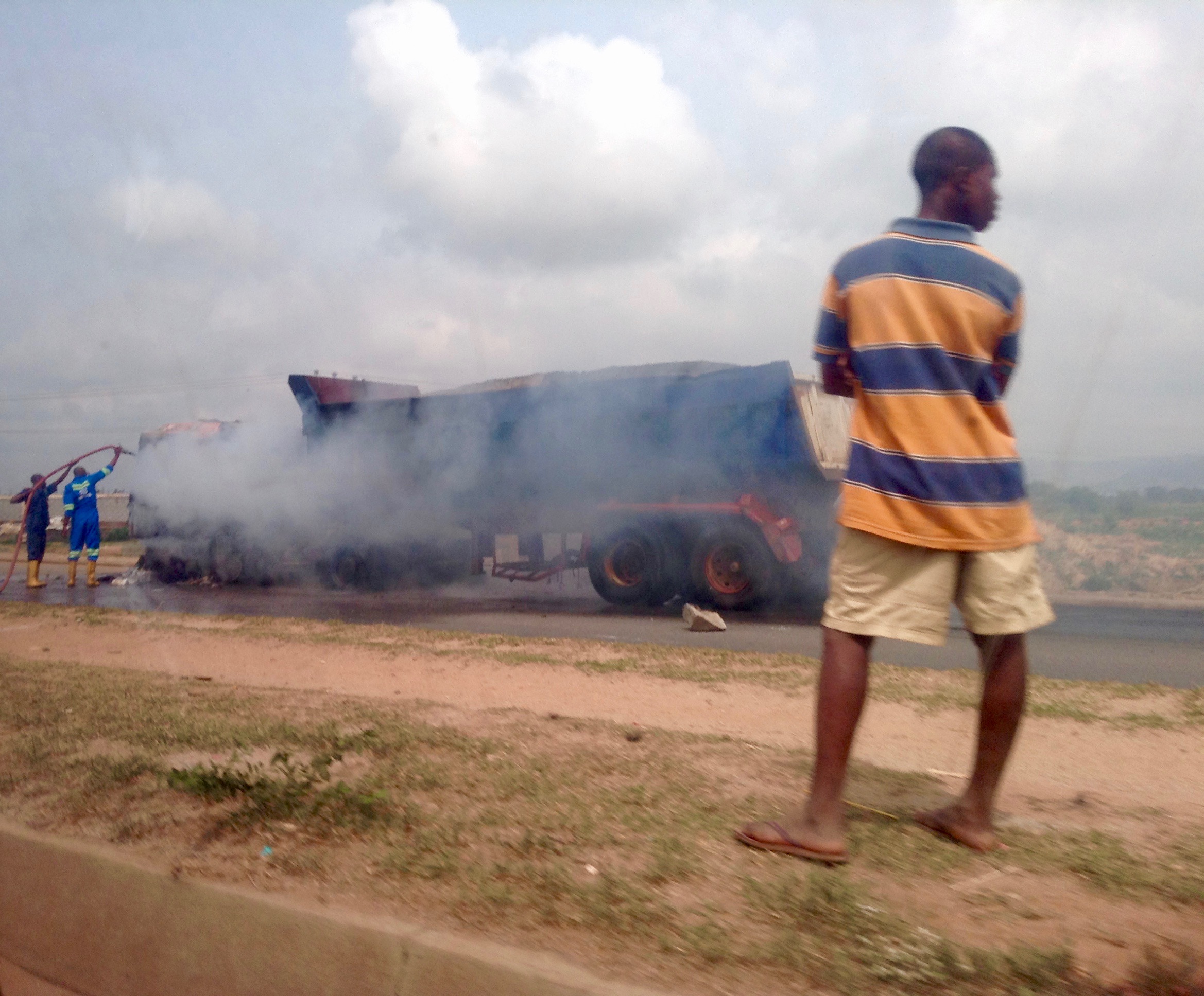 Nigerian Fire Brigade fighting semi trailer truck fire on Abuja highway.