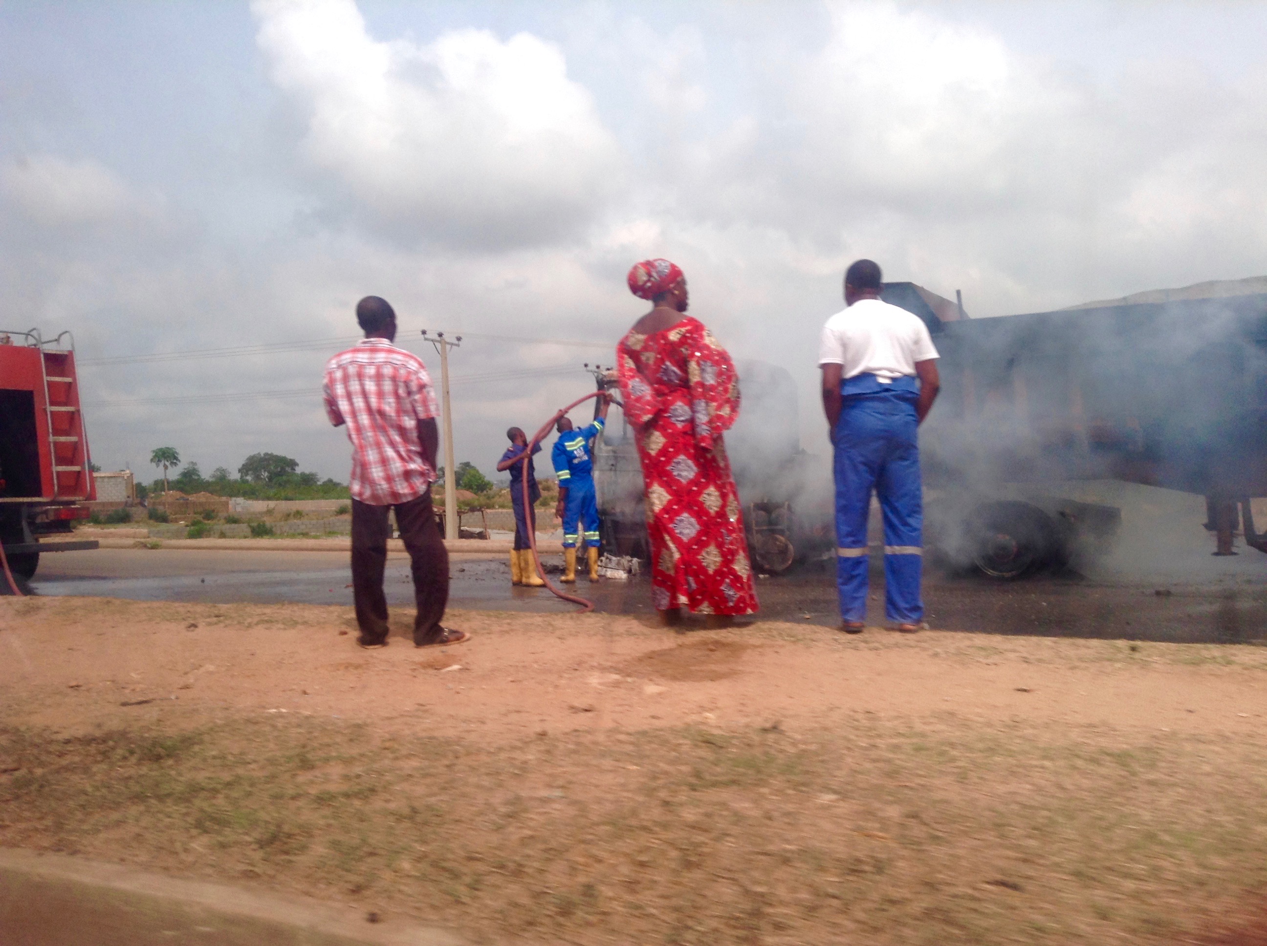 Nigerian Fire Brigade fighting semi-trailer truck fire on Abuja highway.