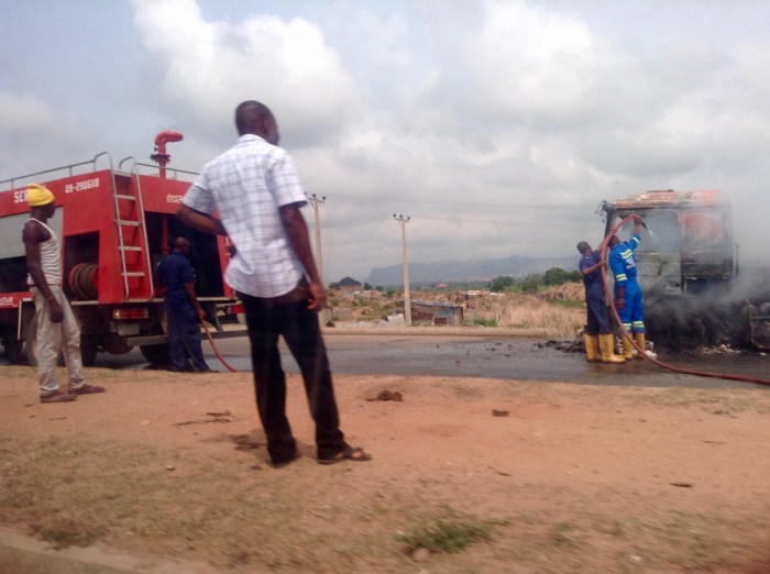 Nigerian Fire Brigade fighting semi-trailer truck fire on Abuja highway.