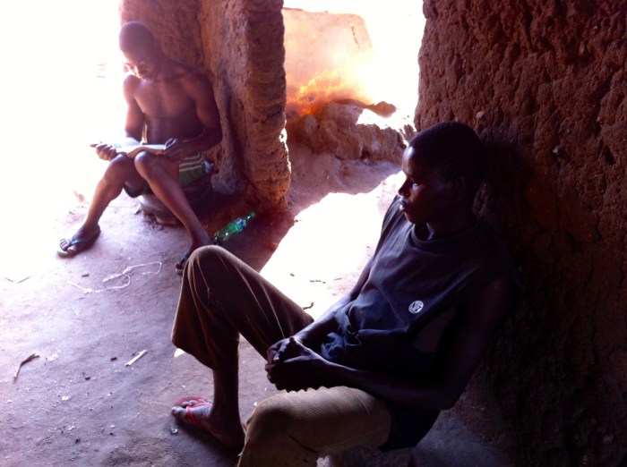 Igbira farm boy reading in a red mud hot, Kogi, Nigeria. #JujuFilms